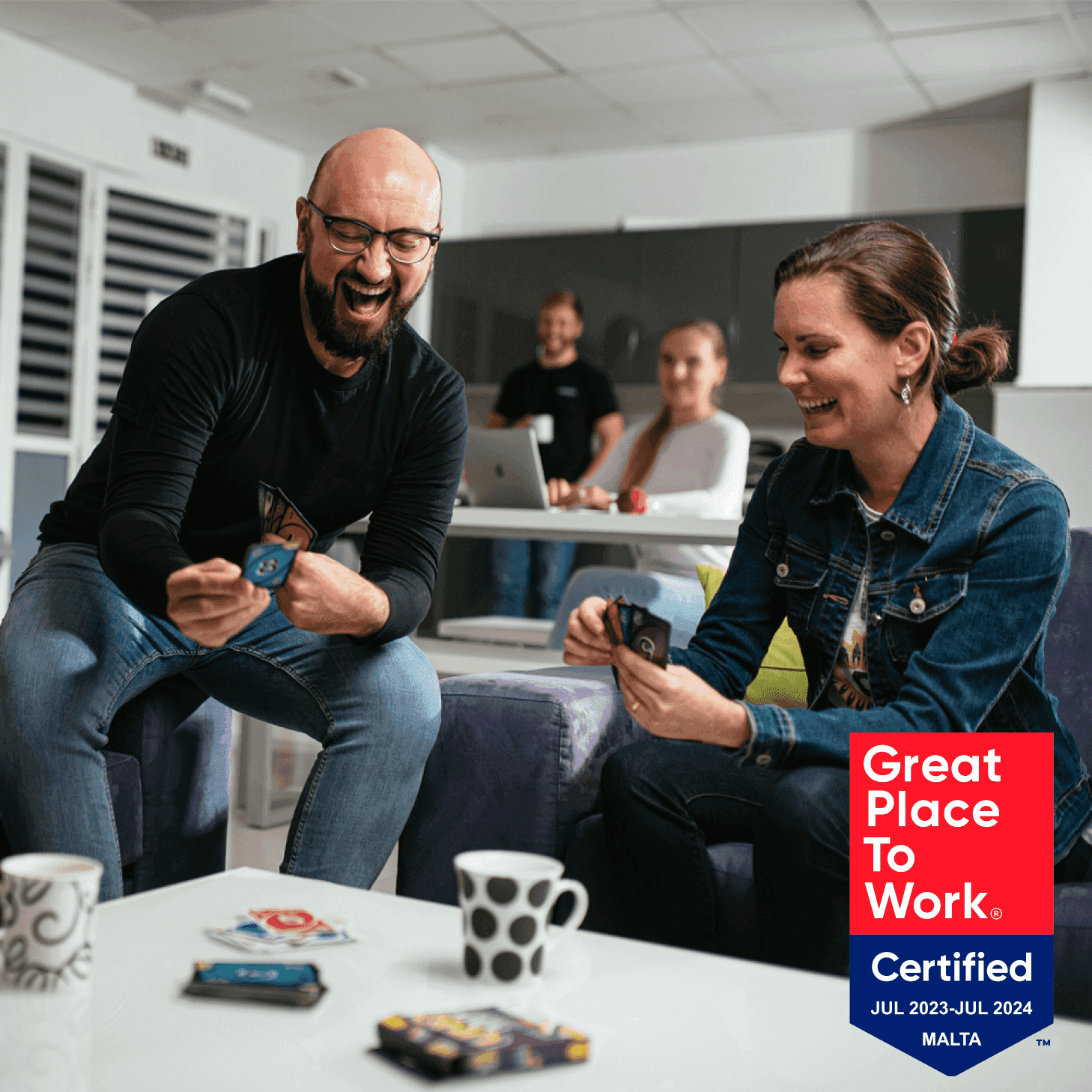 Group playing foosball