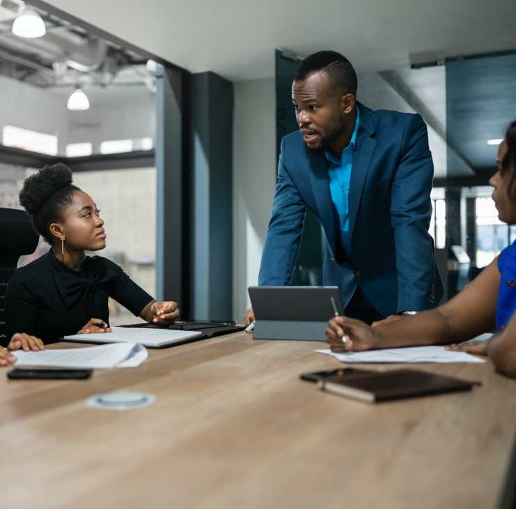Man standing and explaining to the team
